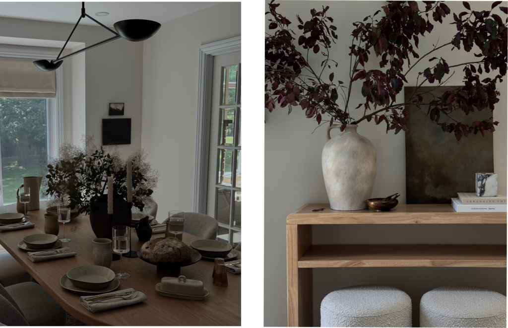 Left side: An elegantly set wooden dining table in a bright room, featuring ceramic plates, linen napkins, wine glasses, and a fresh loaf of artisan bread. A large, dark ceramic vase filled with delicate, wispy branches sits in the center of the table beneath a modern black sculptural light fixture.
Right side: A light wood console table decorated with a large, rustic cream-colored ceramic urn holding deep burgundy leafy branches. A dark abstract painting rests on the table behind a small stack of books, and two round, textured white bouclé stools are tucked neatly underneath.